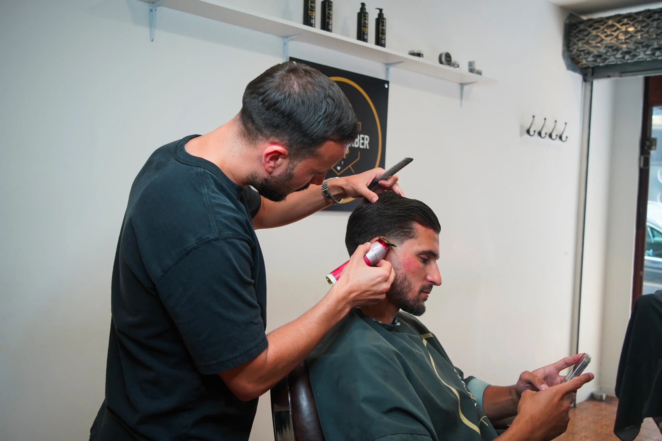 Man getting a professional haircut at a modern barber salon
